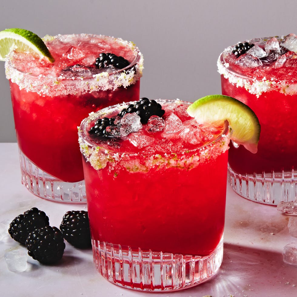 Blackberry Margarita blended pink blackberry margarita with a rugar rim, lime wedge and blackberries