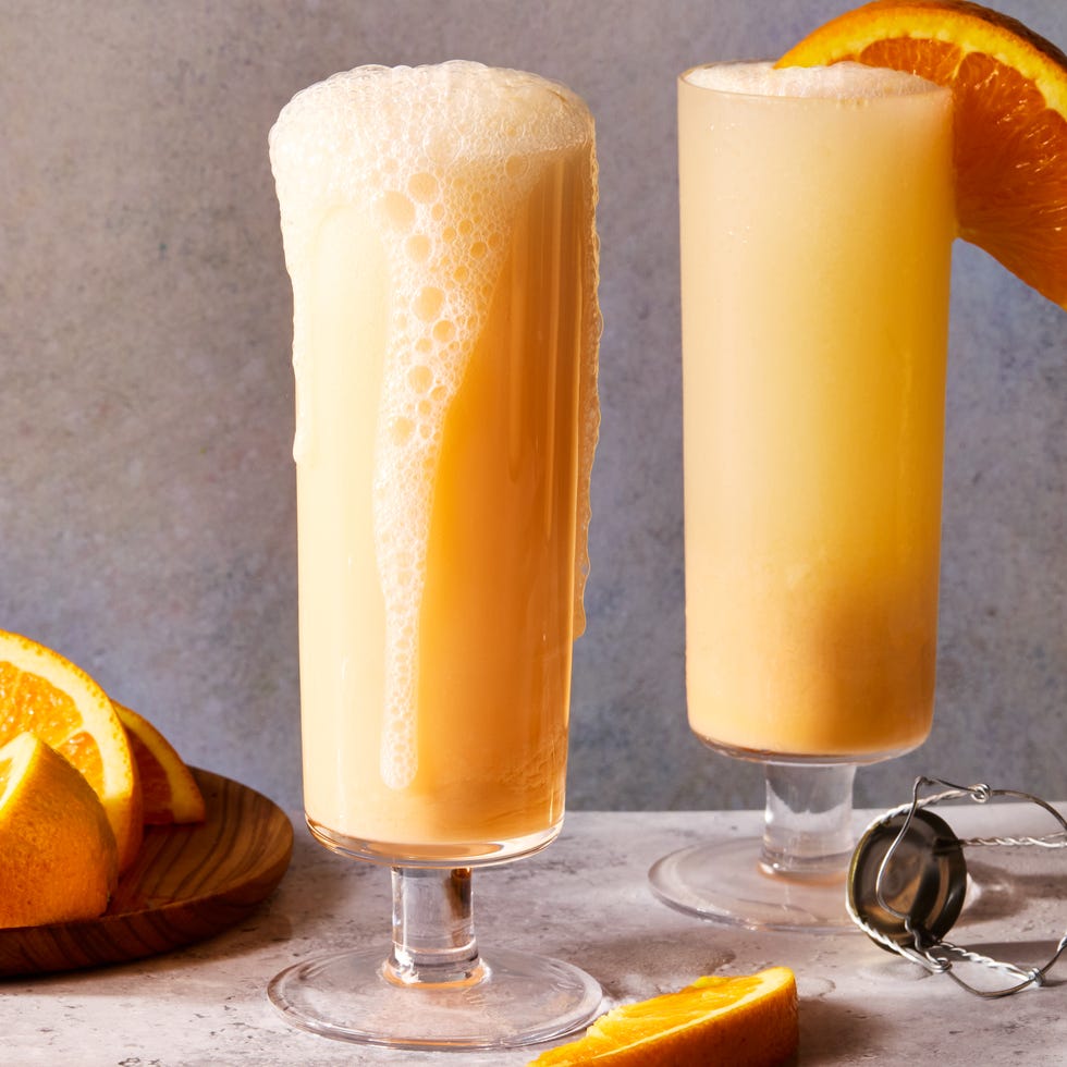 Creamsicle Mimosas creamsicle mimosas filled with ice and garnished with an orange wedge