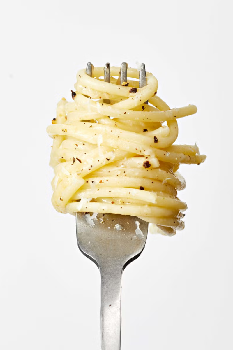 cheesy lemon pepper spaghetti twirled on a fork