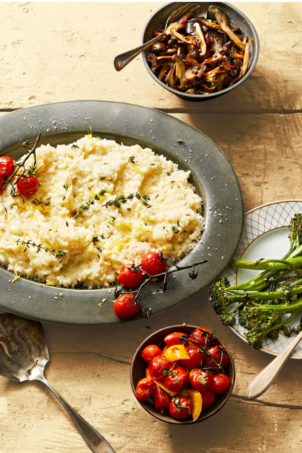 a bowl of risotto and roasted tomatoes on top