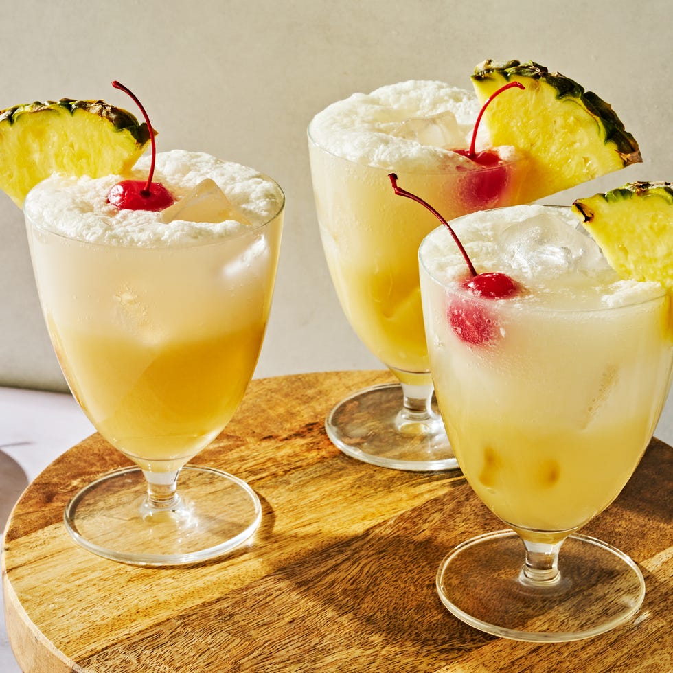 Pina Colada Spritz pina colada spritz topped with a maraschino cherry and a pineapple wedge