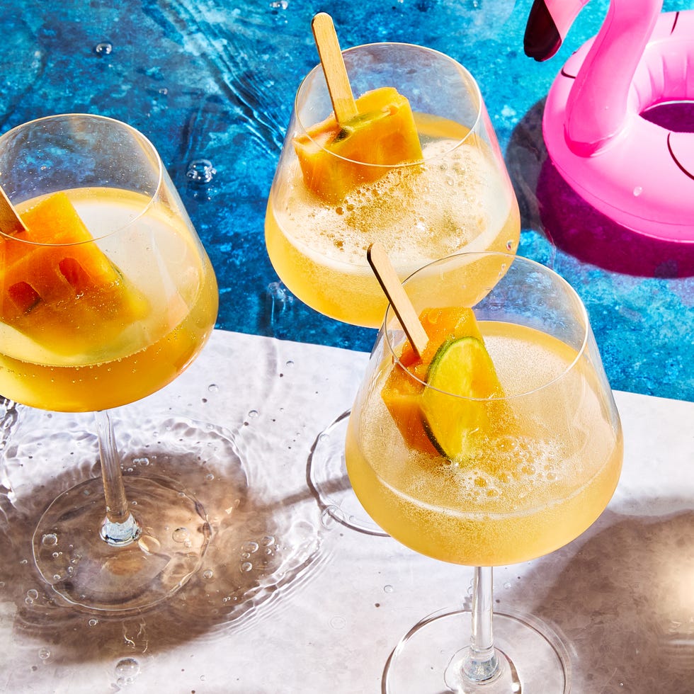 Poolside Popsicle Spritzer spritz with orange popsicles in them by a pool