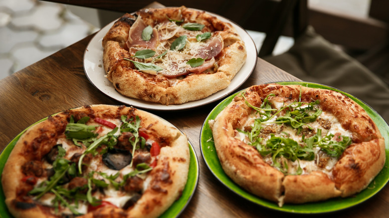 three perfectly baked pizzas
