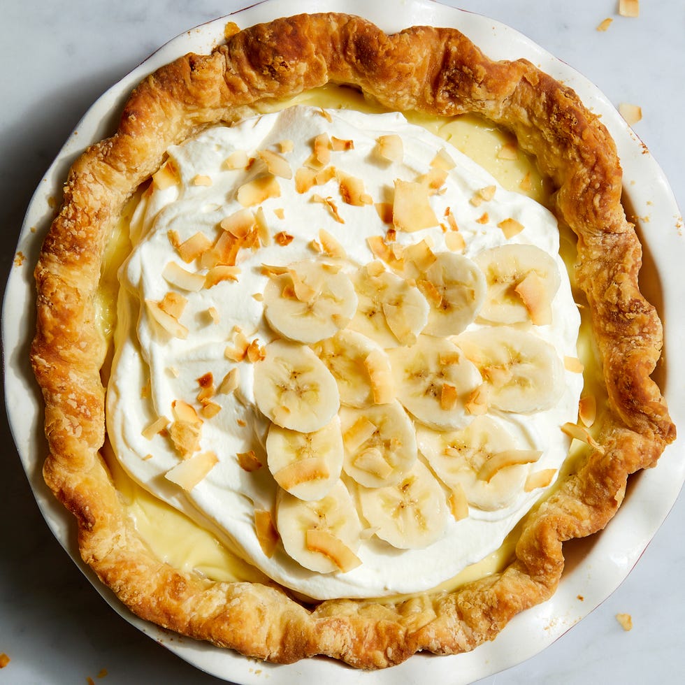 Banana Cream Pie banana cream pie topped with banana slices and toasted coconut flakes
