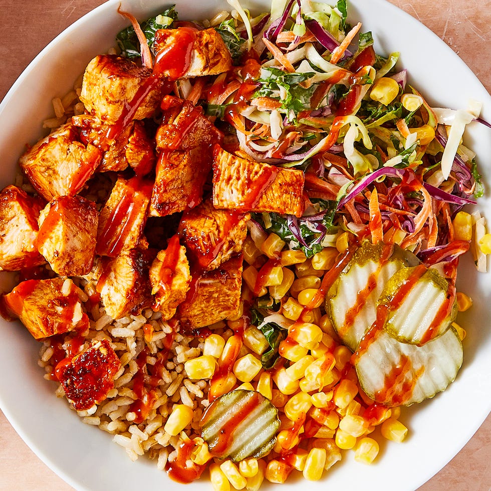 BBQ Protein Bowl bbq chicken in a grain bowl with corn, pickles, and slaw