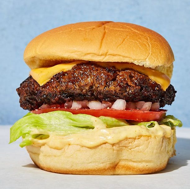 Burger cheeseburger with onions, tomatoes, lettuce and sauce