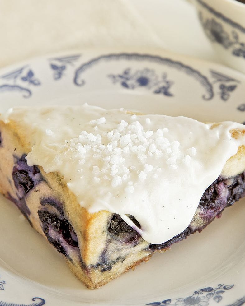 blueberry desserts blueberry scones with vanilla icing blueberry scones with vanilla icing on white and blue plate