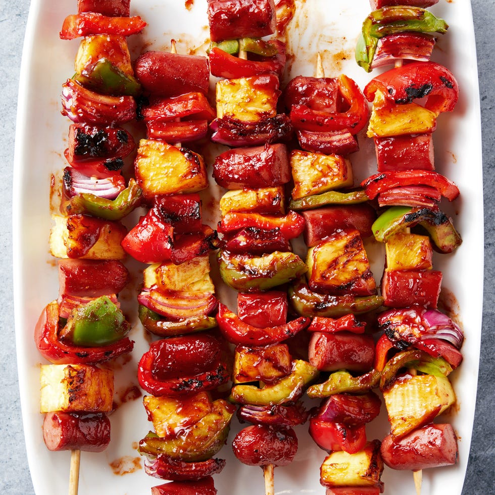 Campfire Hot Dog Skewers grilled skewers with sliced hot dogs, pineapple, red bell peppers basted with a bbq sauce