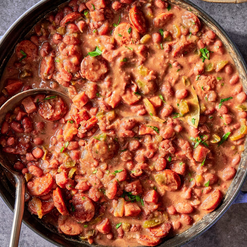 Red Beans and Rice a creole classic with tender, creamy red beans stewed in smoked ham and andouille sausage and flavored with holy trinity vegetables, then served over steamed rice
