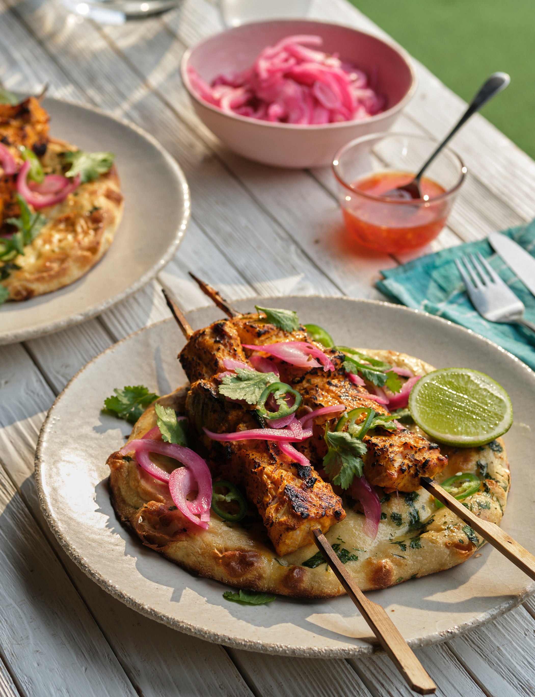 Marinated salmon meets pickled onions and naan – it’s giving barbecue upgrade, not afterthought