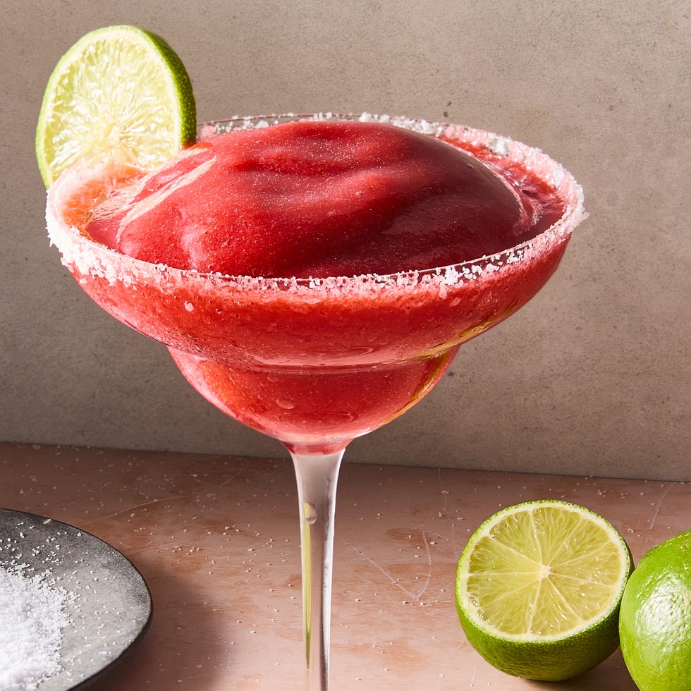 Frozen Strawberry Margarita frozen strawberry margarita in glass with a salt rim and lime garnish