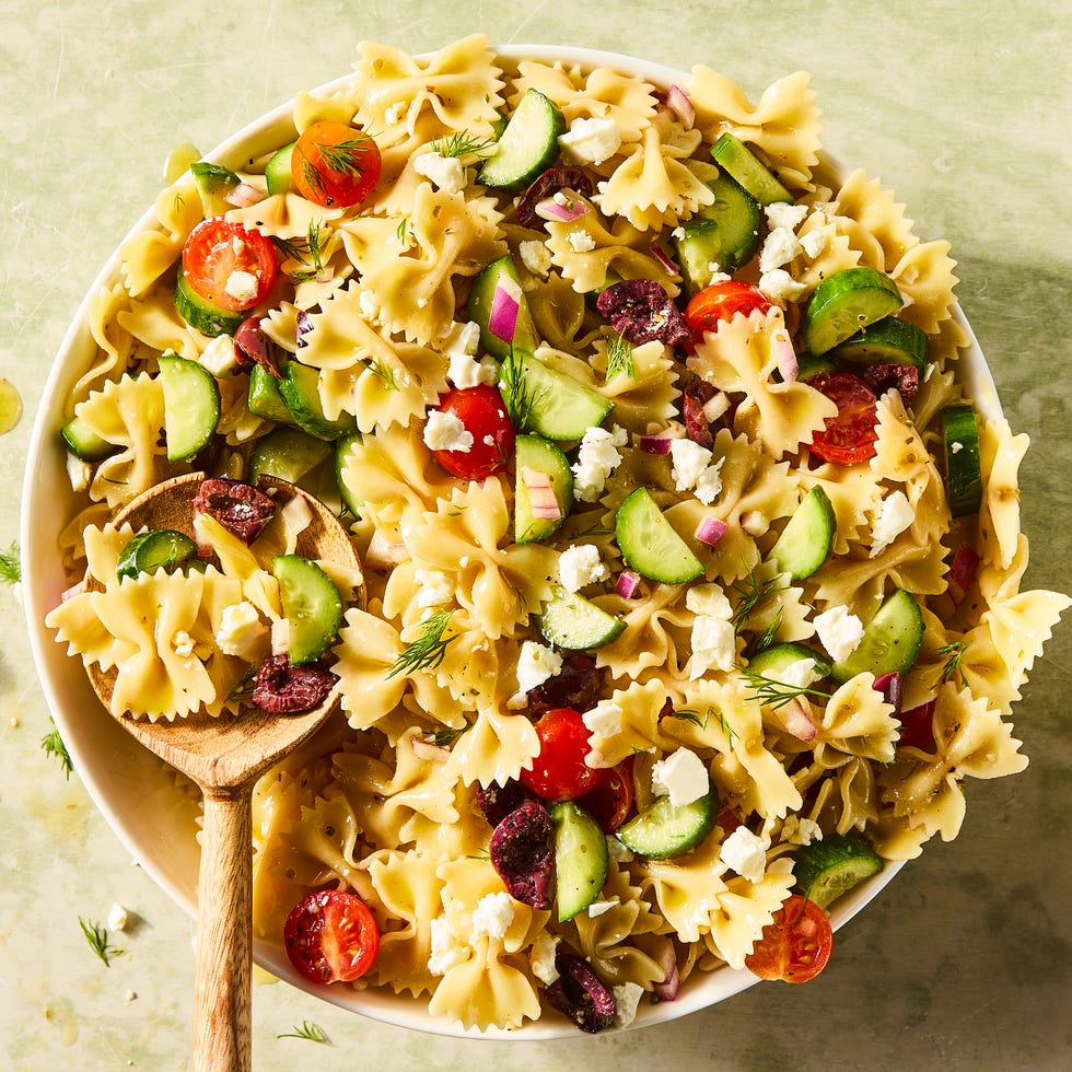 Greek Pasta Salad bowtie pasta tossed with cherry tomatoes, cucumbers, feta, and olives