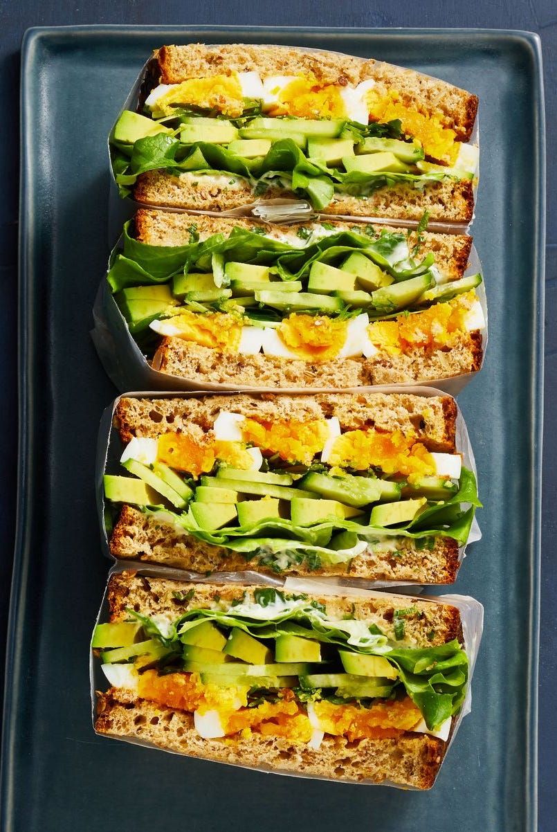 a stack of egg and avocado sandwiches