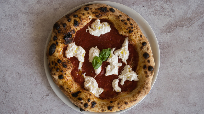 a homemade pizza with very puffy crust