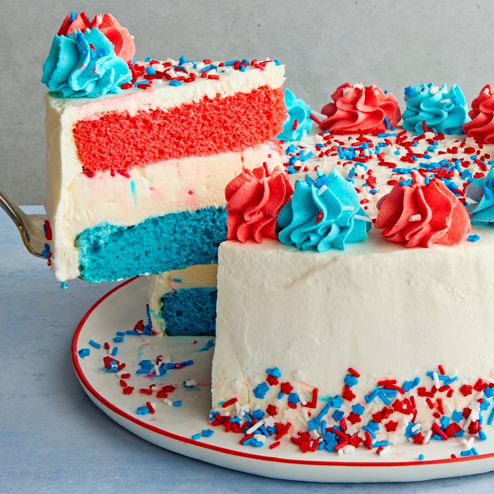 July 4th Ice Cream Cake ice cream cake layered with blue, white, and red, topped with blue and white dollops of icing and sprinkles