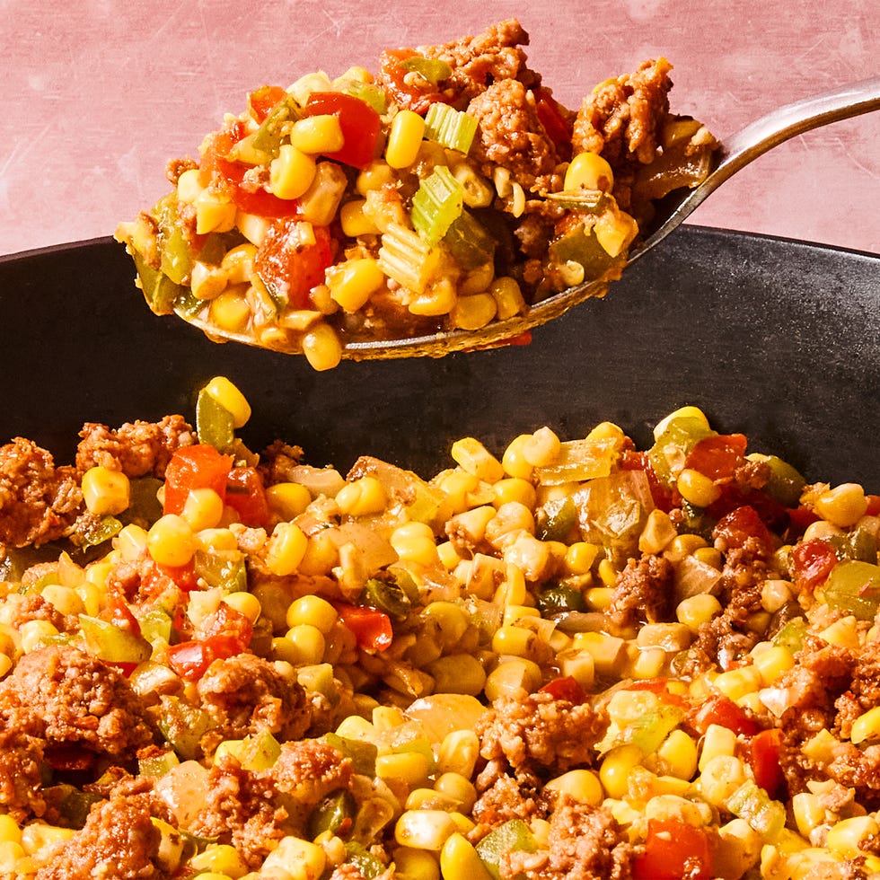 Maque Choux with Sausage sausage, corn, and peppers in a skillet