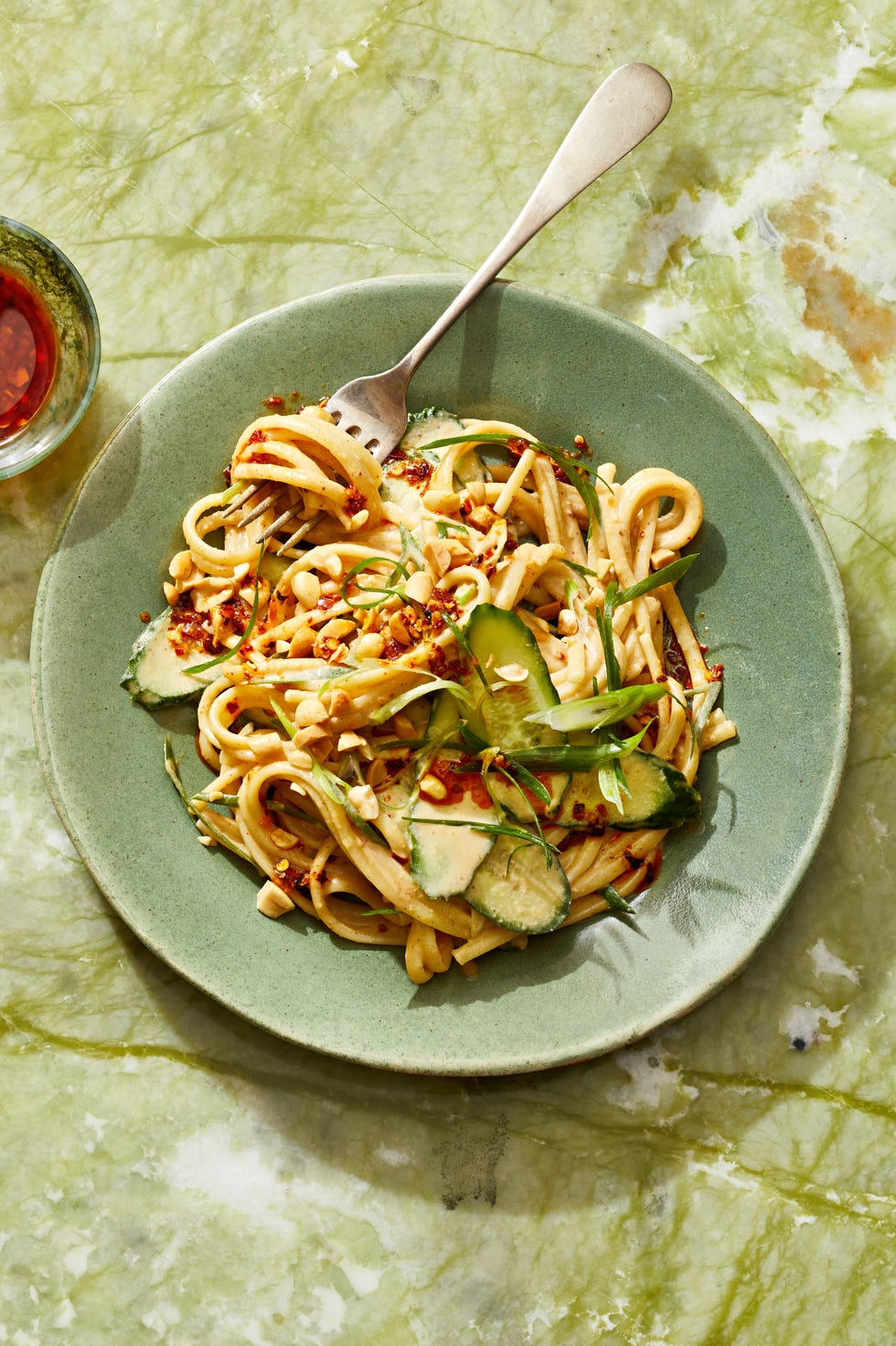 sesame noodles with peanuts and cucumber served on top