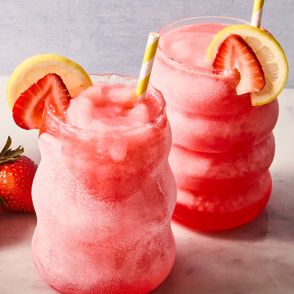 Spiked Pink Lemonade Slushies spiked pink lemonade slushies with sliced strawberries and lemon