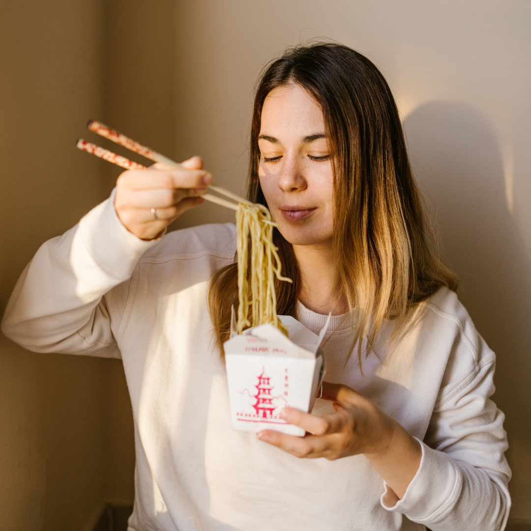 woman eating Chinese takeout