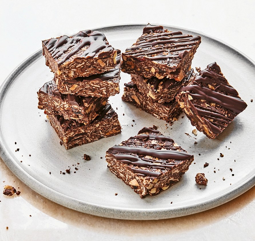 Chocolate-covered granola bars on a plate.