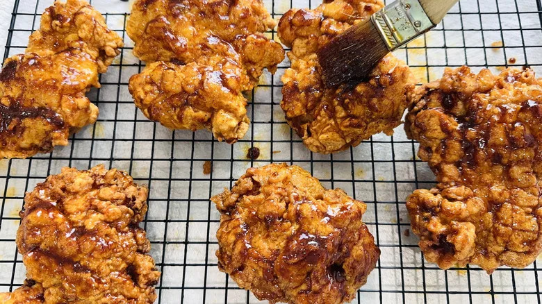 brushing fried chicken with glaze