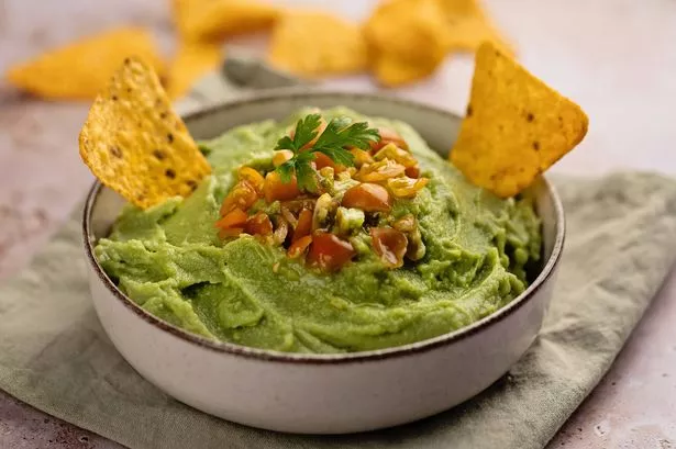 High angle view of guacamole bowl with nachos