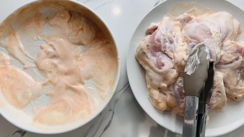 plate with marinated chicken and plate with marinade