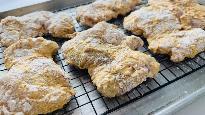 coated chicken thighs on wire rack