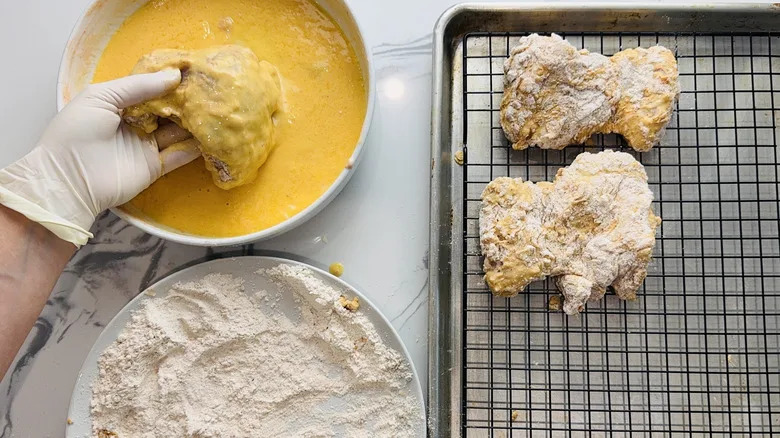 coating chicken thighs with wet and dry batter