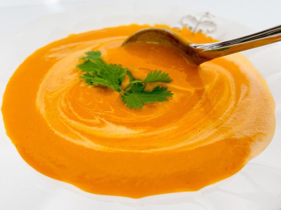 A bowl of creamy carrot lemongrass soup.