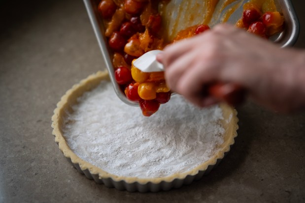 Filling is added to the apricot and Rainier cherry Crostata. (E. Jason Wambsgans/Chicago Tribune)
