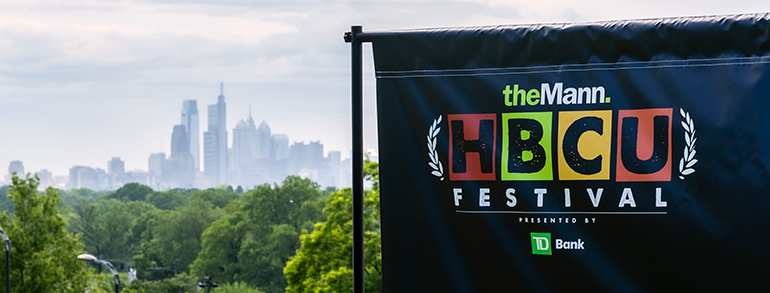 Philadelphia skyline with The Mann HBCU Festival sign