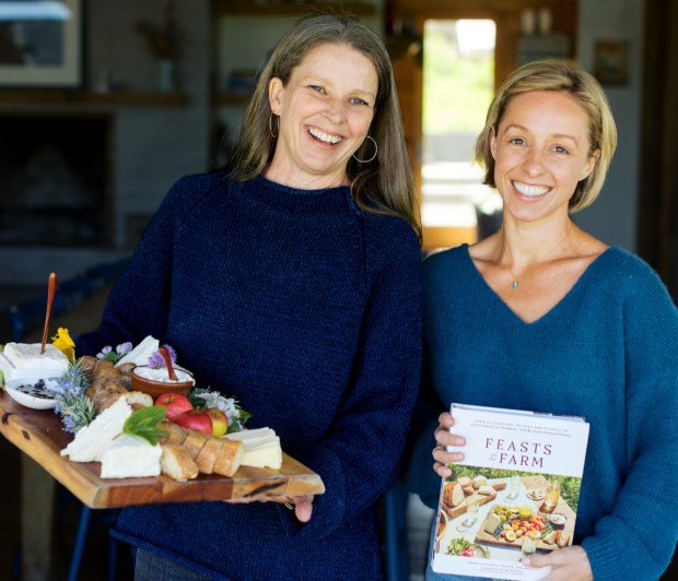 Co-authors Tamara Jo Hicks and Jessica Lynn Macleod with their forthcoming cookbook, "Feasts on the Farm," out Aug. 5. (Courtesy Paige Green)