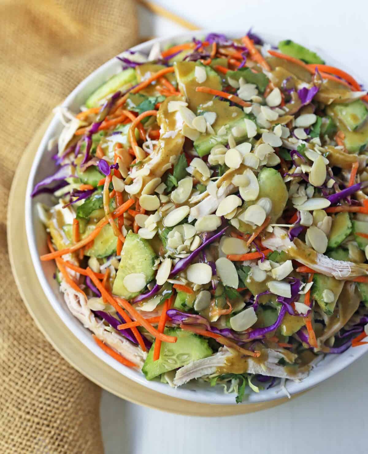 Thai Chicken Salad with Peanut Dressing. Crunchy Thai salad with cabbage, carrots, cucumber, slivered almonds, tender chicken in a homemade peanut dressing. A flavorful Chinese Chicken Salad. www.modernhoney.com #asiansalad #chickensalad #thaichickensalad #chinesechickensalad