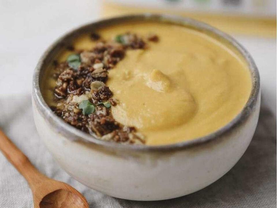 Gluten-free butternut squash soup with almond-oat crumble.
