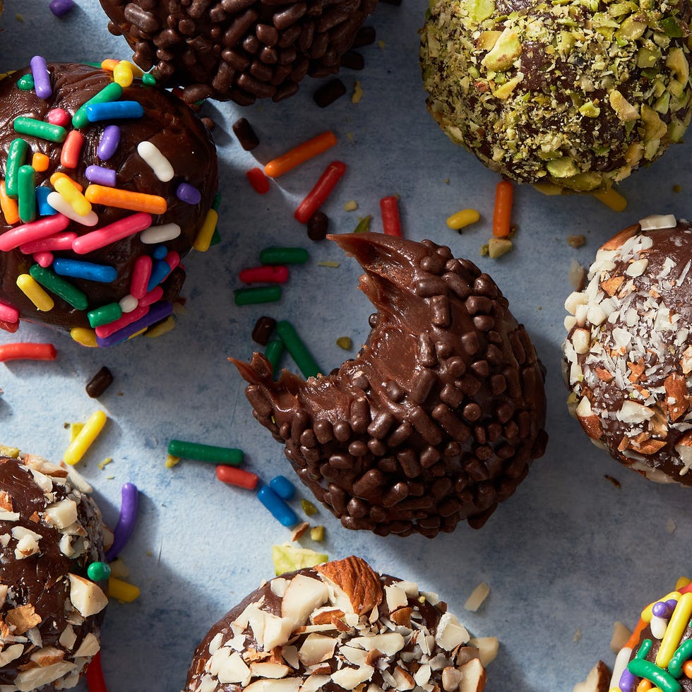 brigadeiros covered in chocolate and rainbow sprinkles, and chopped pistachios and almonds brigadeiros covered in chocolate and rainbow sprinkles, and chopped pistachios and almonds