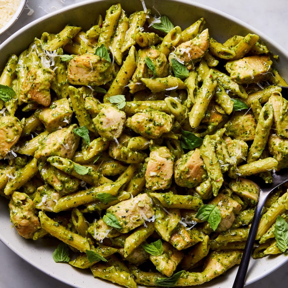 Chicken pesto pasta chicken pesto pasta topped with basil and parmesan cheese