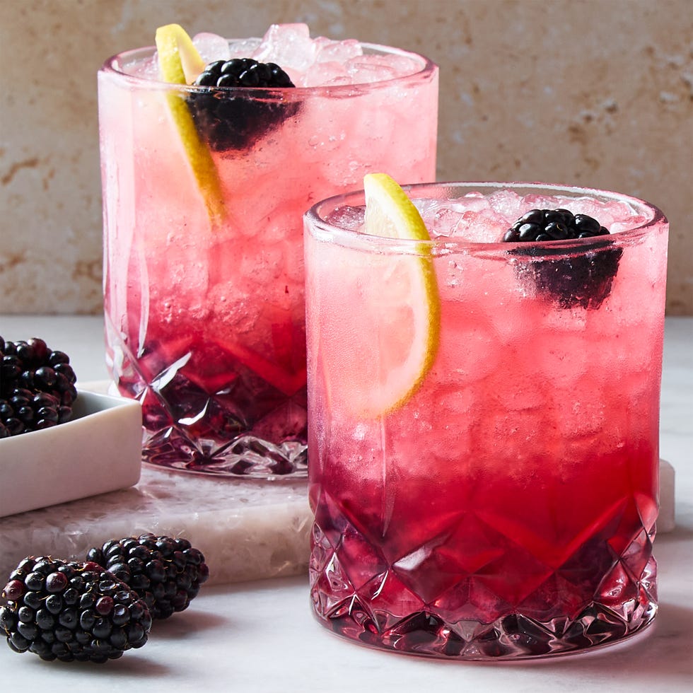 classic bramble cocktail in a cup with ice with a lemon garnish