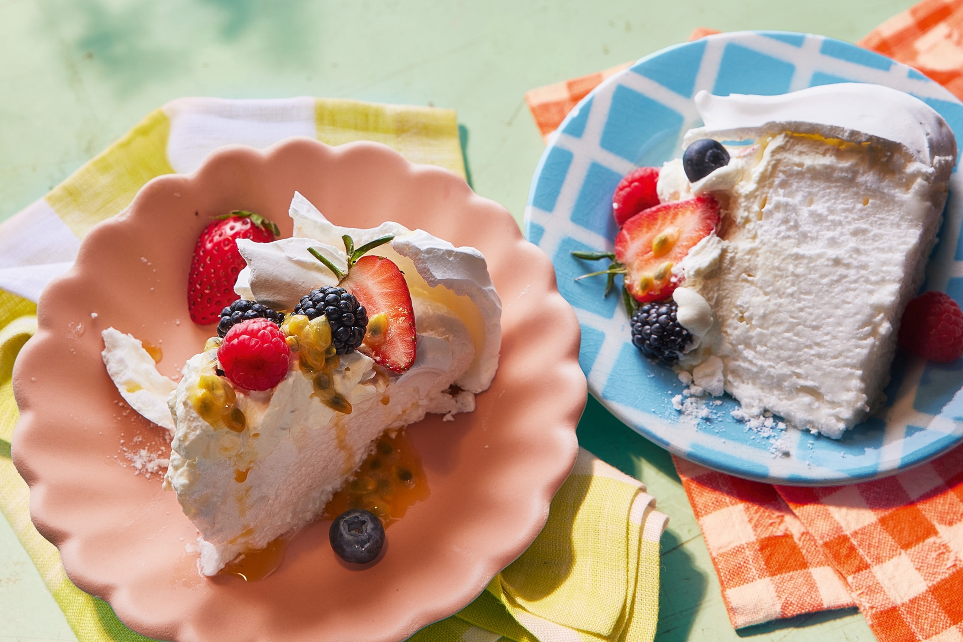 image of a slice of pavlova topped with colourful fruit
