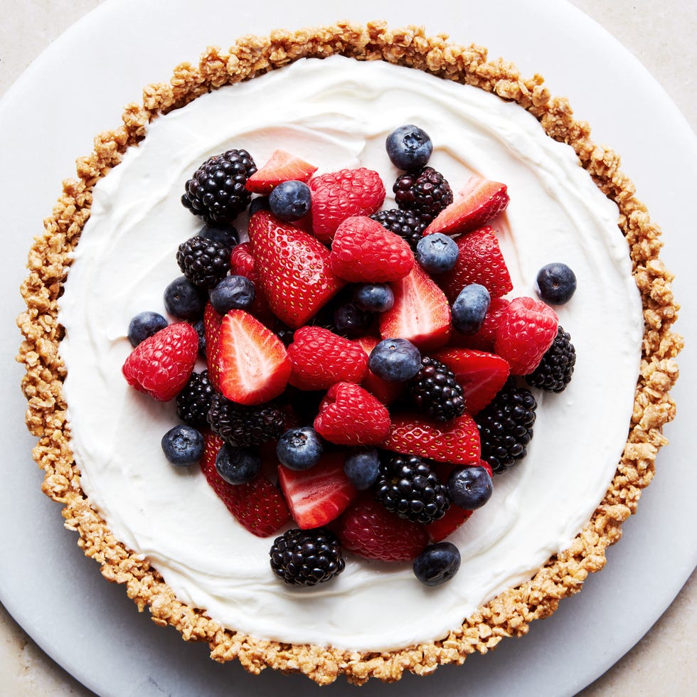 No-bake fruit and granola breakfast tart no bake fruit and granola breakfast tart topped with raspberries, blueberries, blackberries, and strawberries on a platter