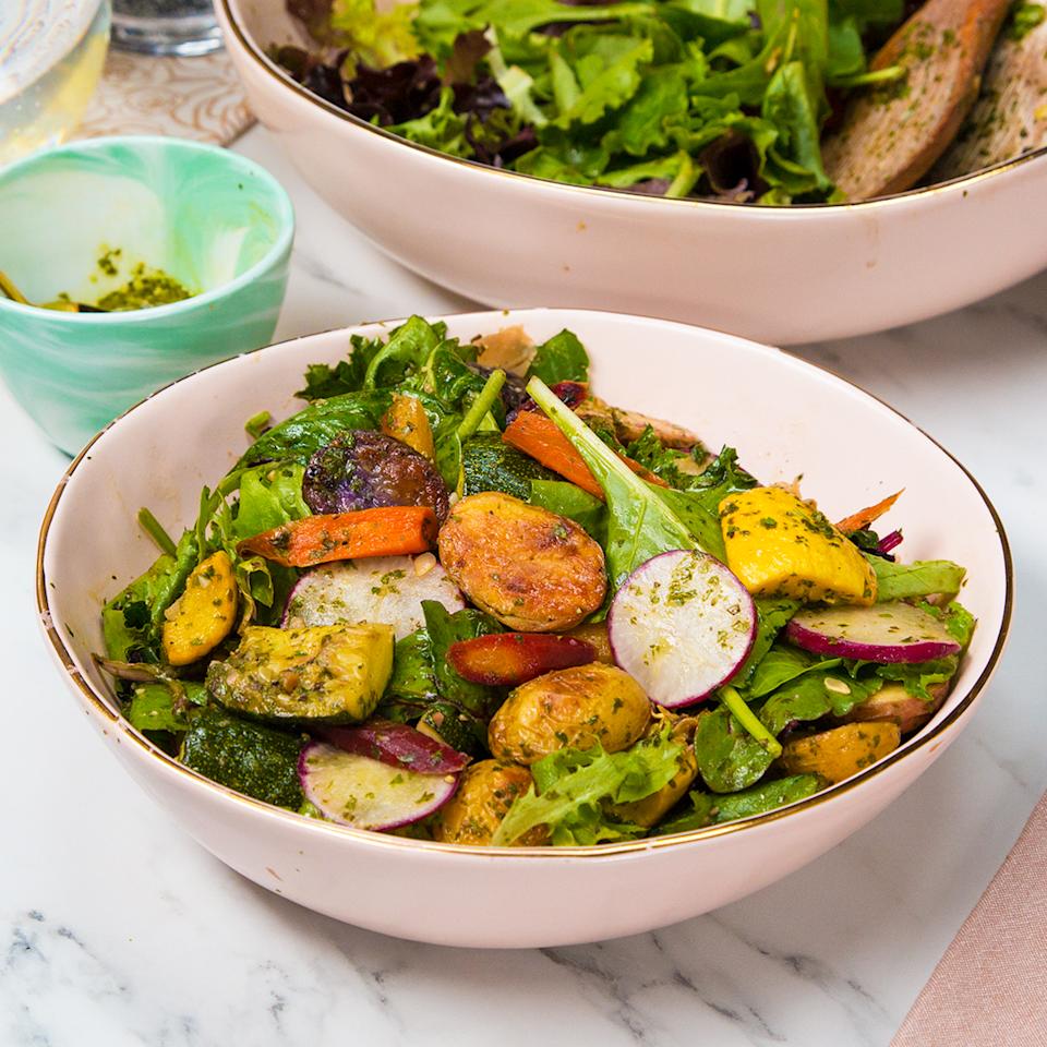 Fresh salad with mixed greens, roasted vegetables, radishes, and a light vinaigrette in a bowl