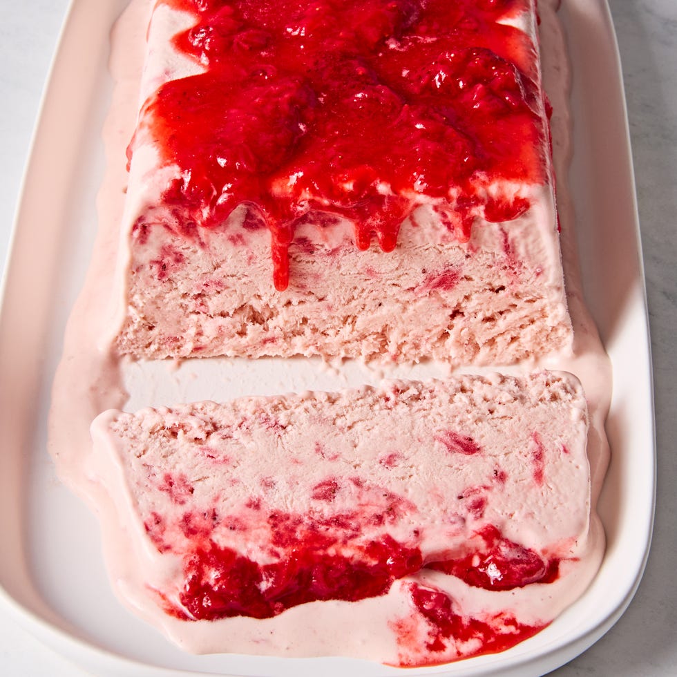 Strawberries & Cream Semifreddo strawberries and cream semifreddo topped with a fresh strawberry sauce on a plate