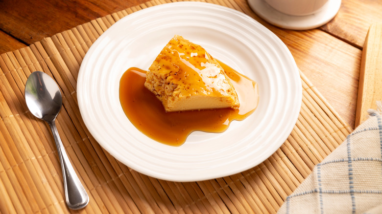 Flan on white plate with spoon