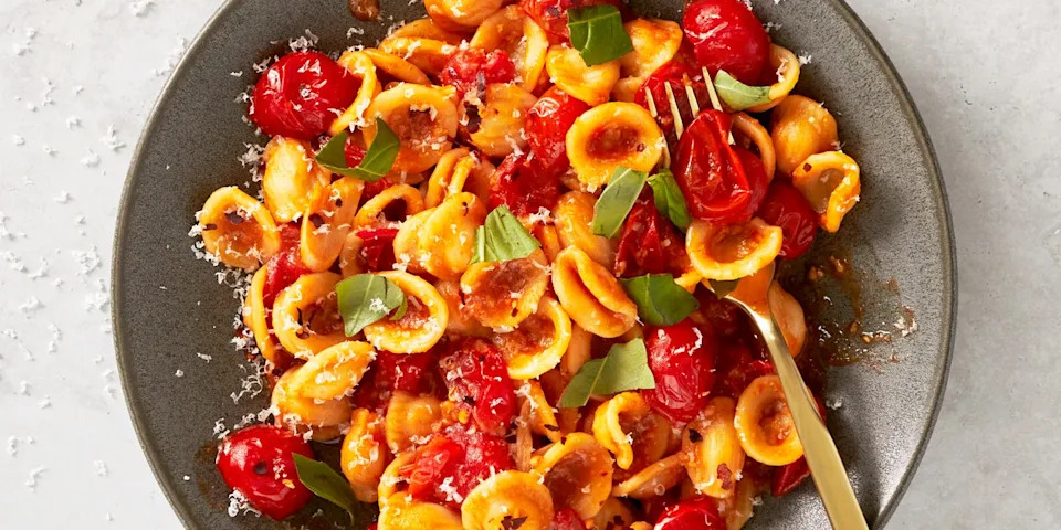 cherry tomato pasta with burst cherry tomatoes and fresh basil