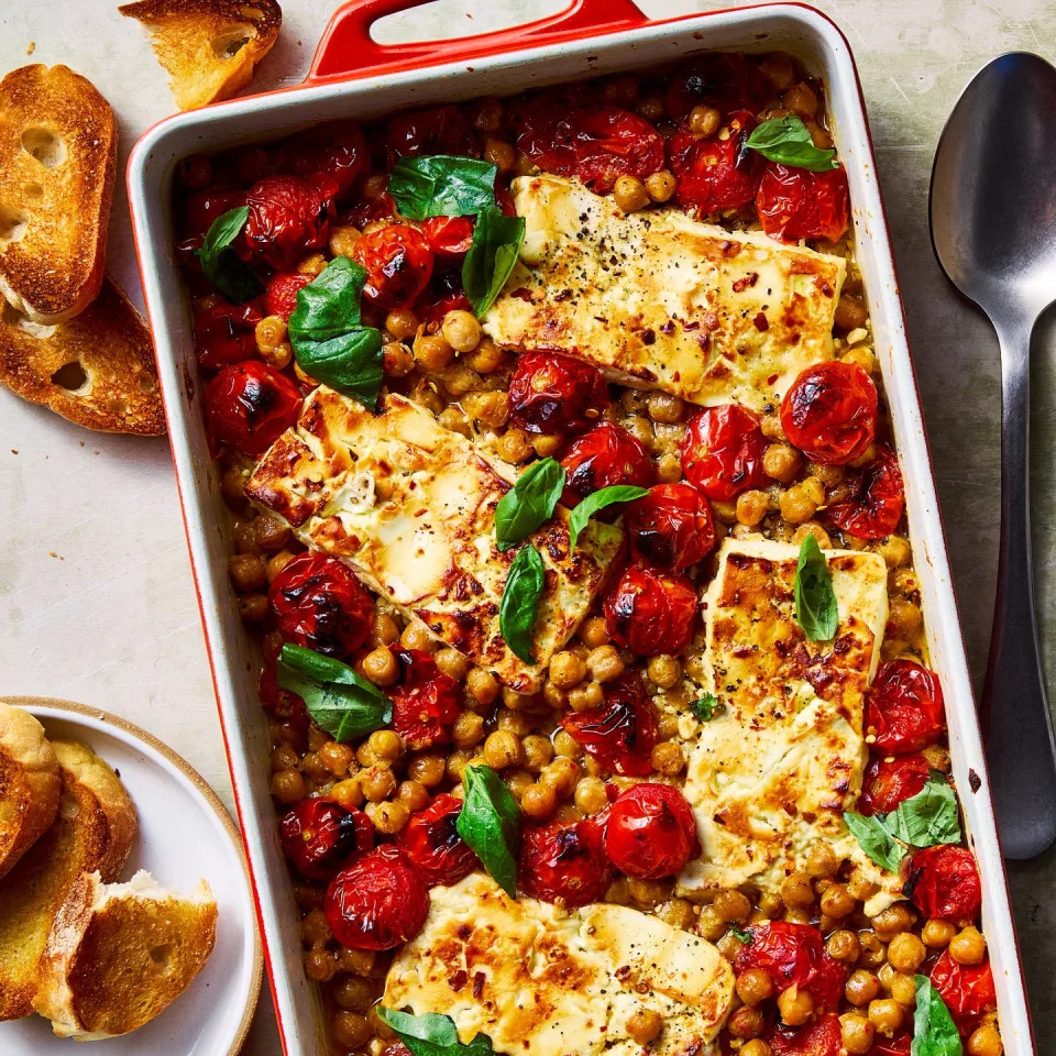 baked feta chickpeas with roasted tomatoes topped with basil