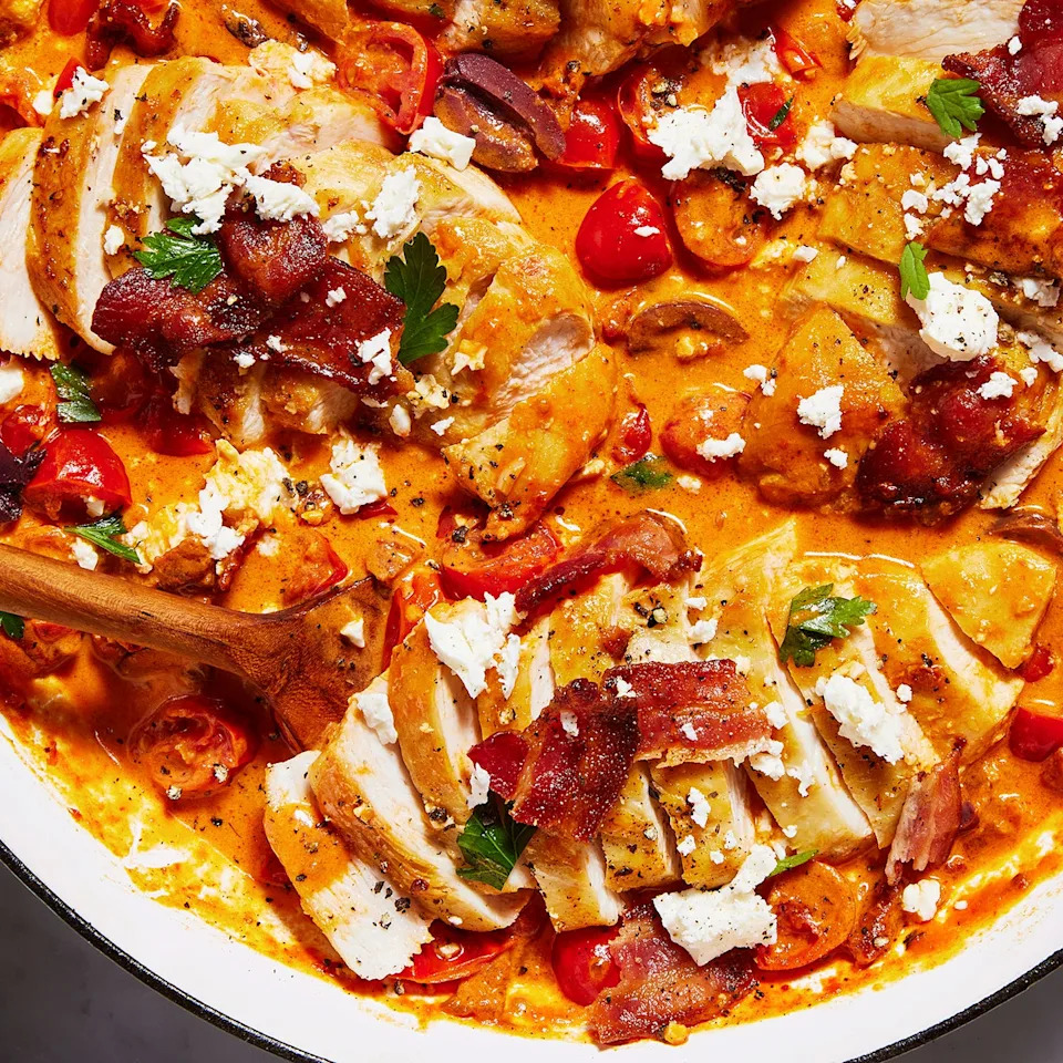 chicken breasts in a creamy sauce with tomatoes, feta, bacon and olives