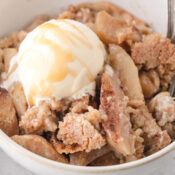 apple crisp without oats topped with homemade vanilla ice cream and caramel sauce