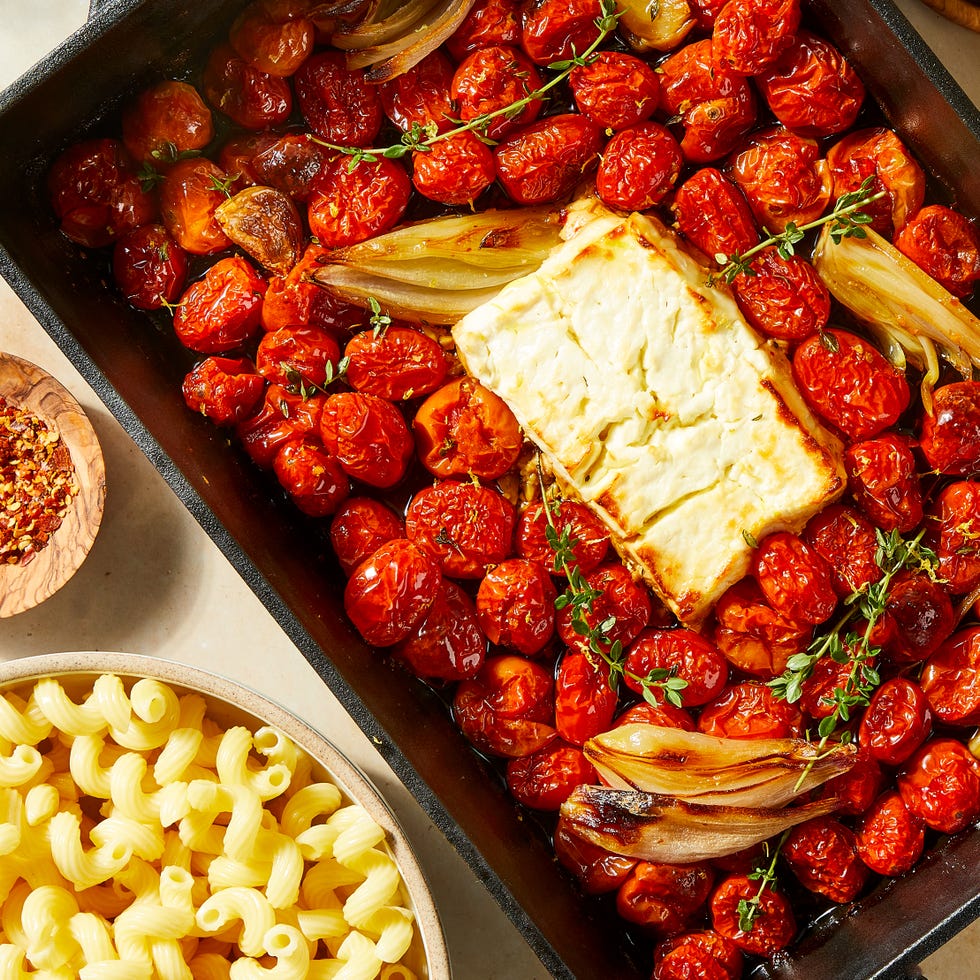 Baked Feta Pasta baked feta in a pan with roasted cherry tomatoes and shallots