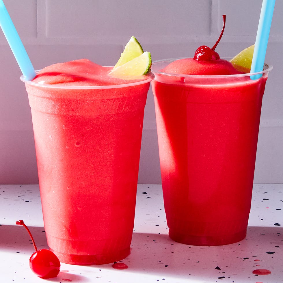 red cherry limeade slushies with lime wedges and cherries