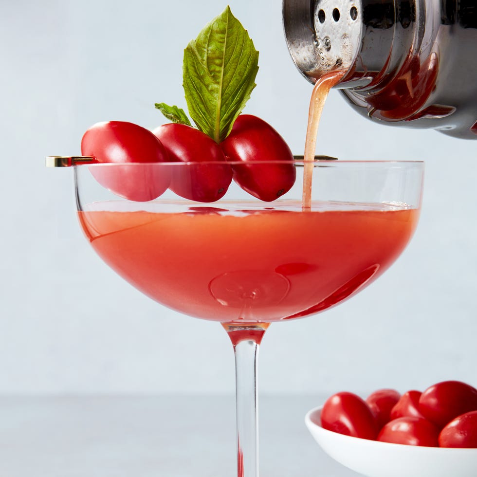Tomato Tini martini glasses with gin, tomato infused vermouth, and a basil leaf